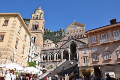 Positano & Amalfi Boat Tour from Naples with Light Lunch - Heading along the coast: ruins, waterfalls, and the Li Galli siren story